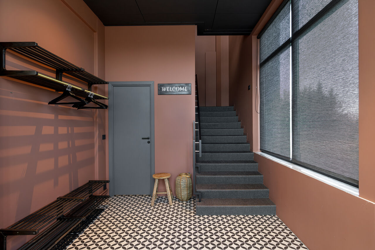 The terracotta staircase climbing through the old bank house