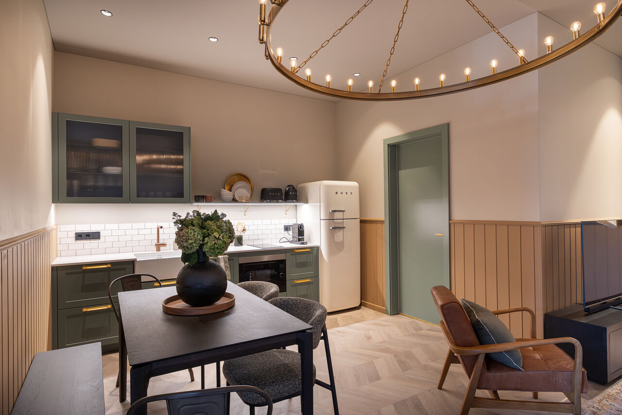 A dining corner under a brass ring chandelier
