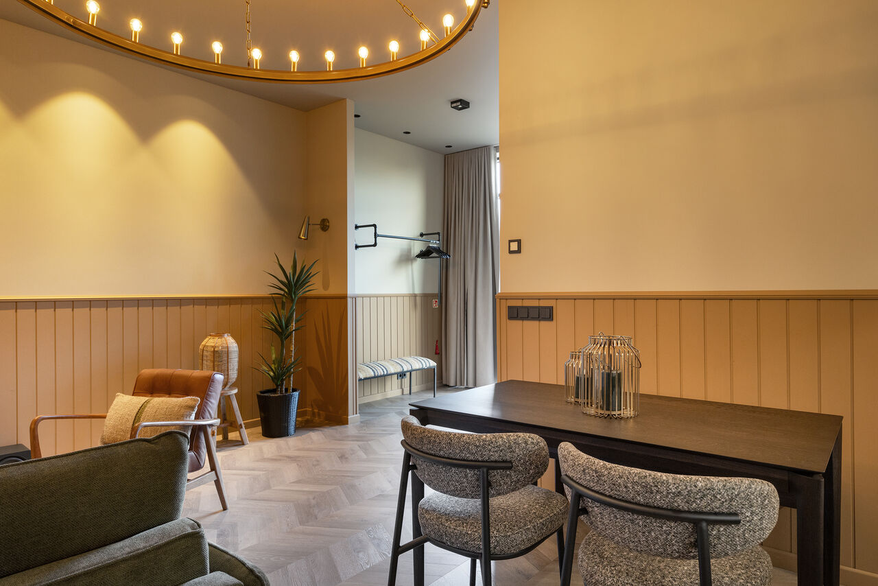 A dining table and chairs by the window in a one-bedroom apartment